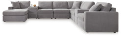 Ashley Furniture Modmax sectional with chaise, featuring modern upholstery and a spacious seating area.