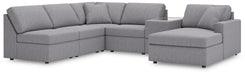 Ashley Furniture Modmax sectional with chaise, featuring plush cushions and modern design in a cozy living room setting.