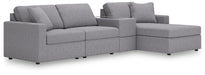 Ashley Furniture Modmax sectional with chaise in a modern design, shown from an angled view highlighting the spacious seating.