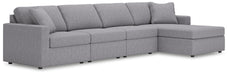 Ashley Furniture Modmax sectional with chaise, showing plush fabric upholstery and modern design in a spacious living room setting.