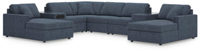 Ashley Furniture Modmax sectional with chaise, featuring modern design and plush cushions in a stylish living room setting.