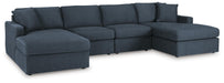 Ashley Furniture Modmax sectional with chaise, featuring plush cushions and modern design, shown in a stylish living room setting.
