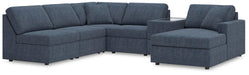 Ashley Furniture Modmax sectional with chaise, featuring modern design and plush upholstery in a spacious living room setting.