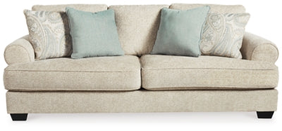 Ashley Furniture Monaghan Sofa with plush cushions and neutral fabric upholstery, shown from a head-on view.