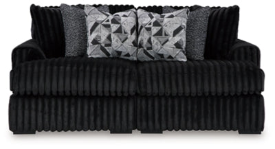 Ashley Furniture Midnight-Madness Super Chaise sectional in dark fabric with plush cushions and sleek design, front view.