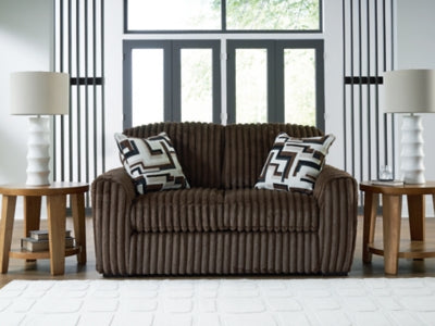 Midnight Madness loveseat by Ashley Furniture, plush dark gray fabric with cushioned armrests and cozy seating.