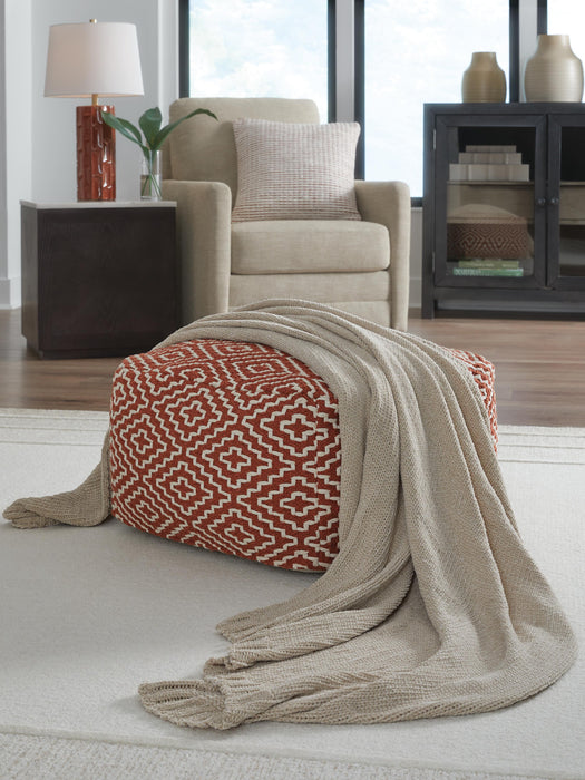 Ashley Furniture Anawood throw blanket with a cozy, woven texture in neutral tones, draped over a surface.