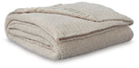 Soft woven Ashley Furniture Anawood throw blanket displayed draped over a sofa in a cozy living room setting.