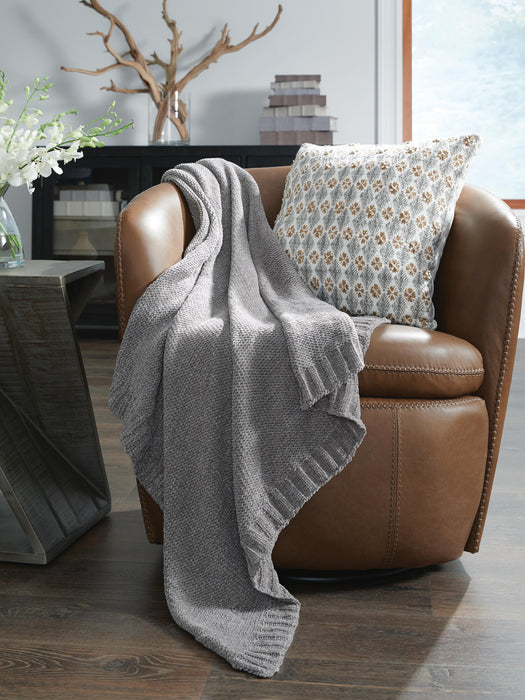 Ashley Furniture Anawood throw blanket featuring a cozy, textured design in warm earthy tones, perfect for adding style and comfort.