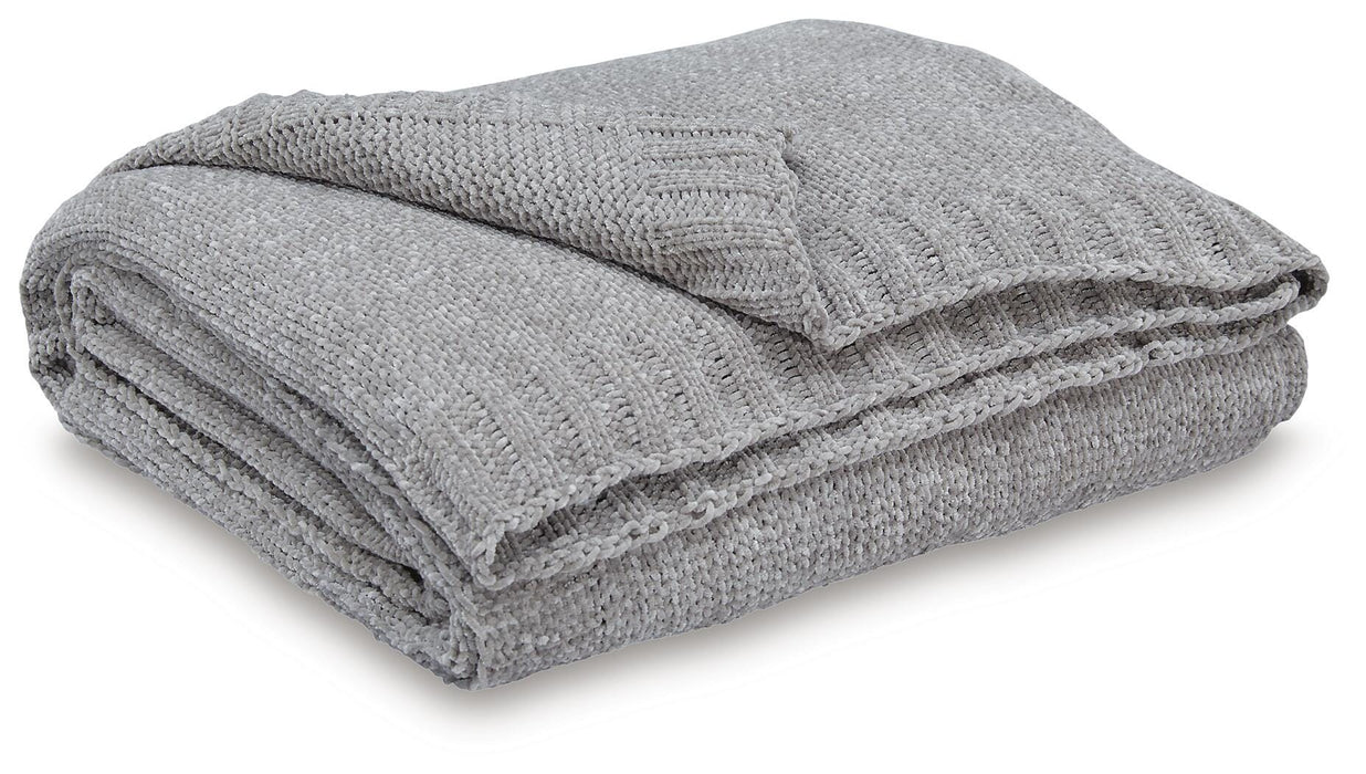 Ashley Furniture Anawood throw blanket featuring a cozy woven design, perfect for adding warmth and style to your living space.