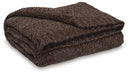 Ashley Furniture Anawood throw blanket featuring a cozy, woven design in neutral tones, perfect for adding warmth and style to a room.