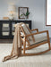 Ashley Furniture Anawood Throw blanket with a cozy, textured fabric in earthy tones, casually draped on a sofa.