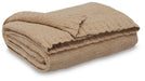 Ashley Furniture Anawood throw blanket with a cozy, textured fabric in warm, natural tones, perfect for living room decor.