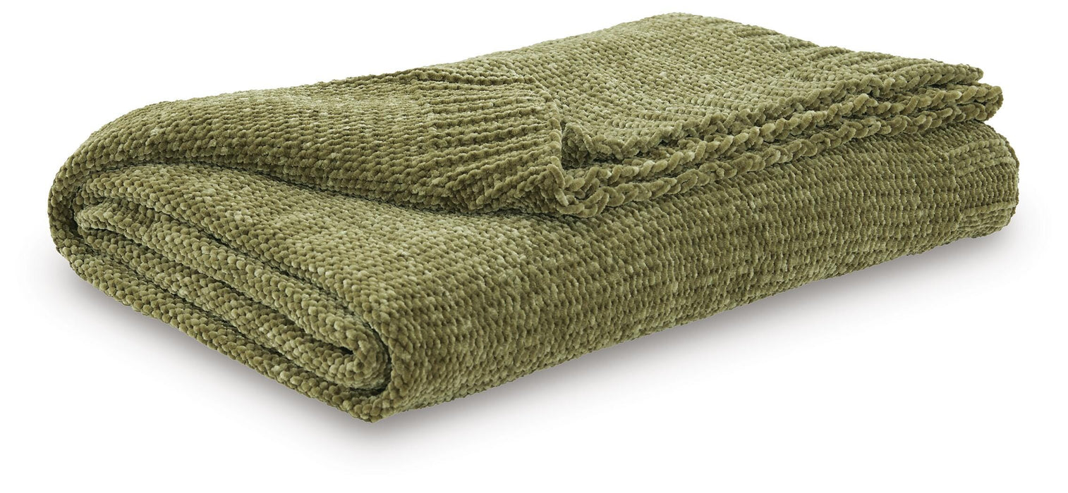 Ashley Furniture Anawood throw blanket featuring a cozy, textured fabric in earthy tones, perfect for adding warmth to your living space.