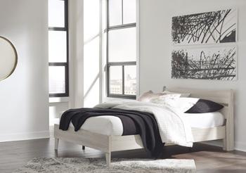 Ashley Furniture Socalle Panel Bed with a sleek wooden frame and modern design, shown in a well-lit bedroom setting.