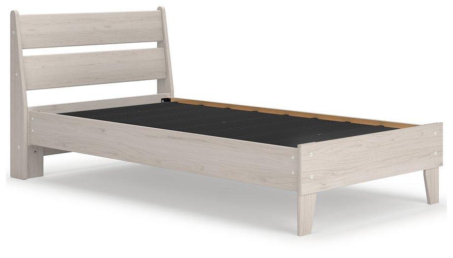 Ashley Furniture Socalle Panel Bed with a wooden headboard and footboard in a modern bedroom setting