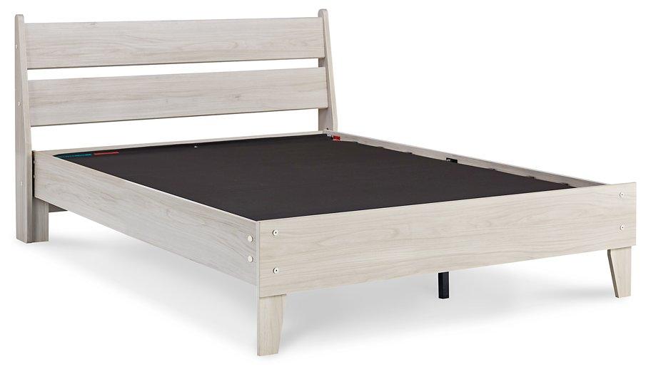 Ashley Furniture Socalle Panel Bed with a wooden frame and headboard, shown in a modern bedroom setting.