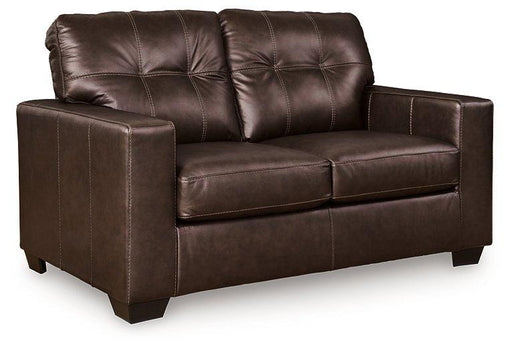 Ashley Furniture Santorine loveseat with plush upholstery and wooden legs, shown in a cozy living room setting.