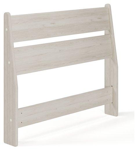 Ashley Furniture Socalle Panel Bed with a classic wooden frame and headboard shown in a cozy bedroom setting.