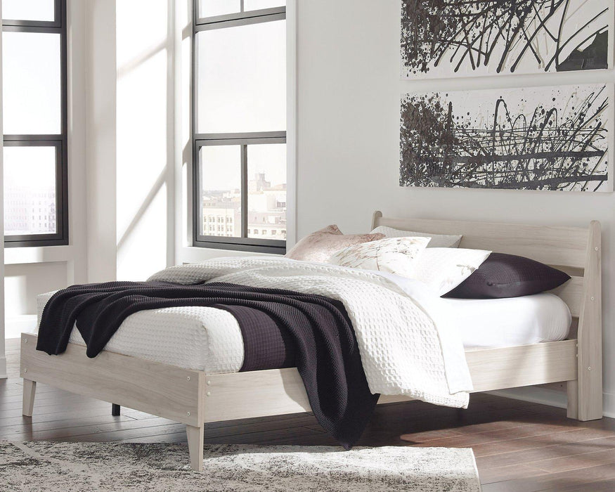 Ashley Furniture Socalle Panel Bed with a sturdy wooden frame and classic design, shown in a well-lit bedroom setting.