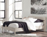 Ashley Furniture Socalle Panel Bed with a sturdy wooden frame and classic design, shown in a well-lit bedroom setting.