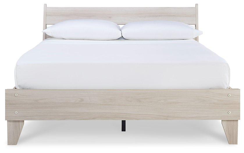 Ashley Furniture Socalle Panel Bed with a sleek wooden frame and modern design, shown in a well-lit bedroom setting.