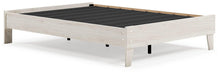Ashley Furniture Socalle Panel Bed with wooden frame and headboard, showcasing a modern bedroom design with a neutral finish.