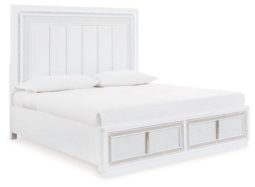 Upholstered storage bed by Ashley Furniture with a padded headboard and built-in storage drawers in a modern bedroom setting