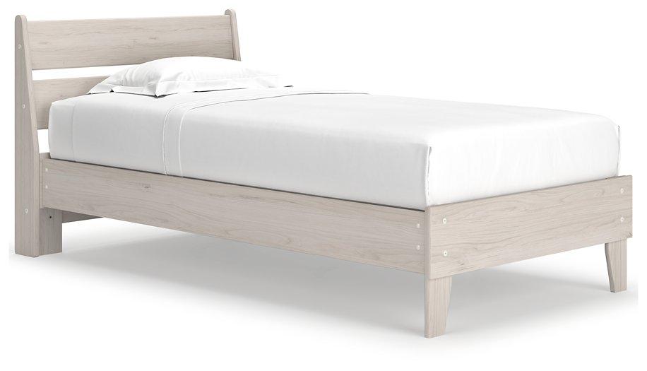 Ashley Furniture Socalle Panel Bed with a wooden frame, headboard with panel details, and a warm finish in a bedroom setting