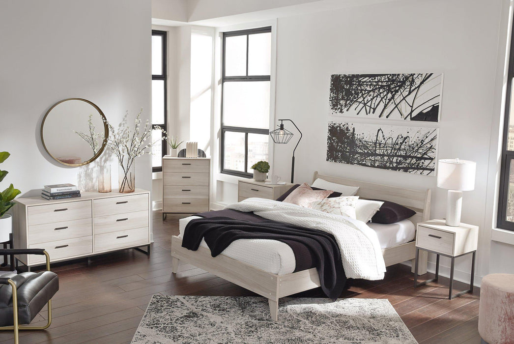 Ashley Furniture Socalle Panel Bed with a modern wooden headboard and frame in a cozy bedroom setting.