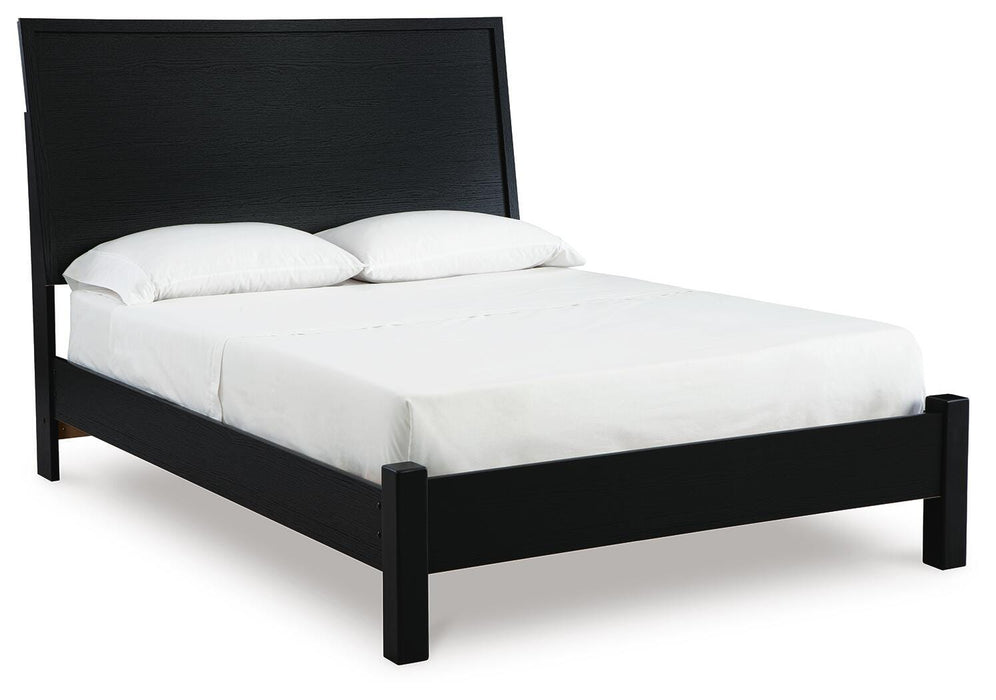 Ashley Furniture Danziar Bed with a stylish frame, shown from a side angle in a modern bedroom setting.