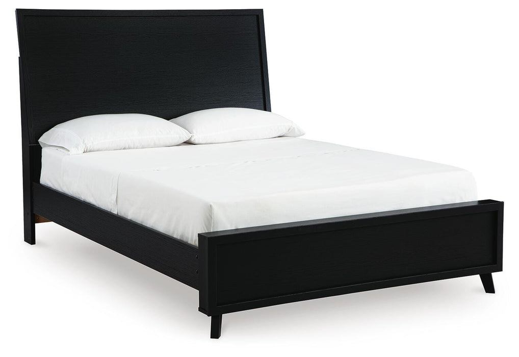 Ashley Furniture Danziar Bed with a sleek wood frame and angled side panels, shown from a side angle.
