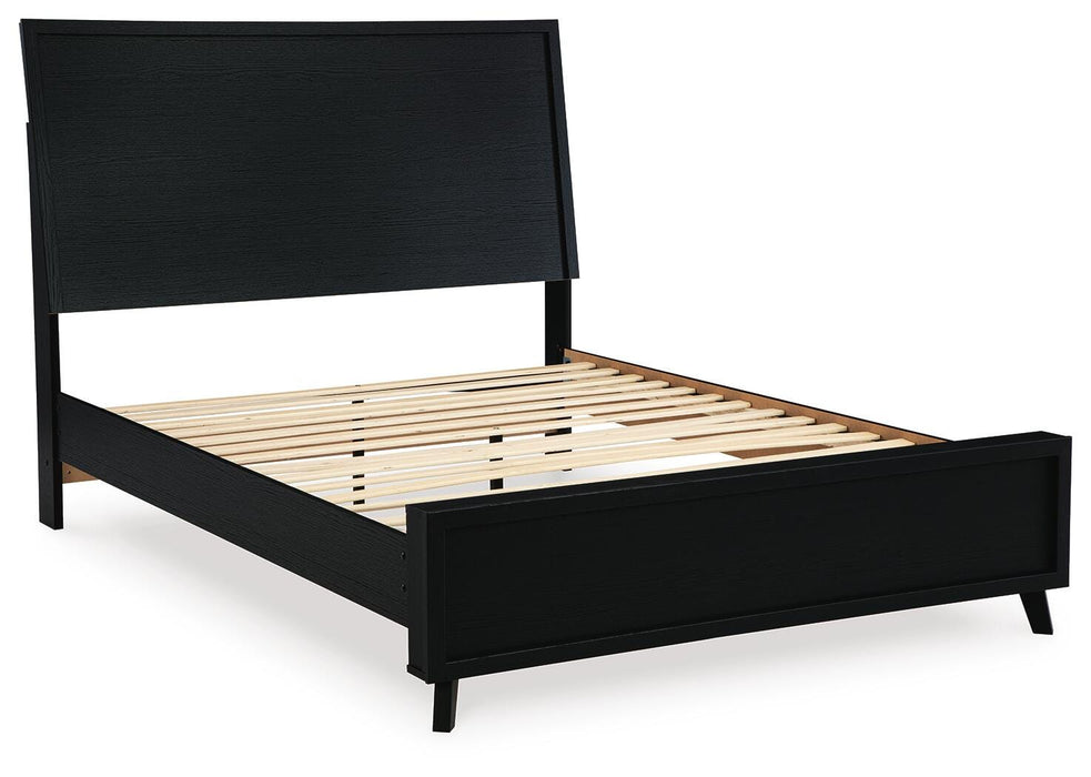 Ashley Furniture Danziar Bed with a modern design, shown from an angled view featuring a sleek, upholstered headboard and wooden frame.