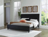 Ashley Furniture Danziar Bed with a wooden frame and neutral upholstered headboard, shown in a modern bedroom setting.