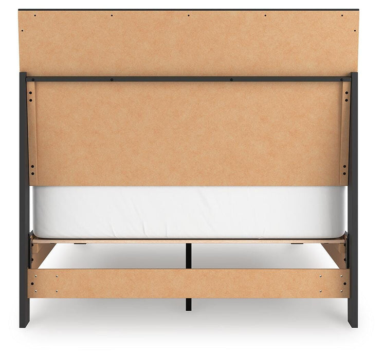 Ashley Furniture Danziar bed with a dark wood finish and upholstered headboard, shown from the back in this image.