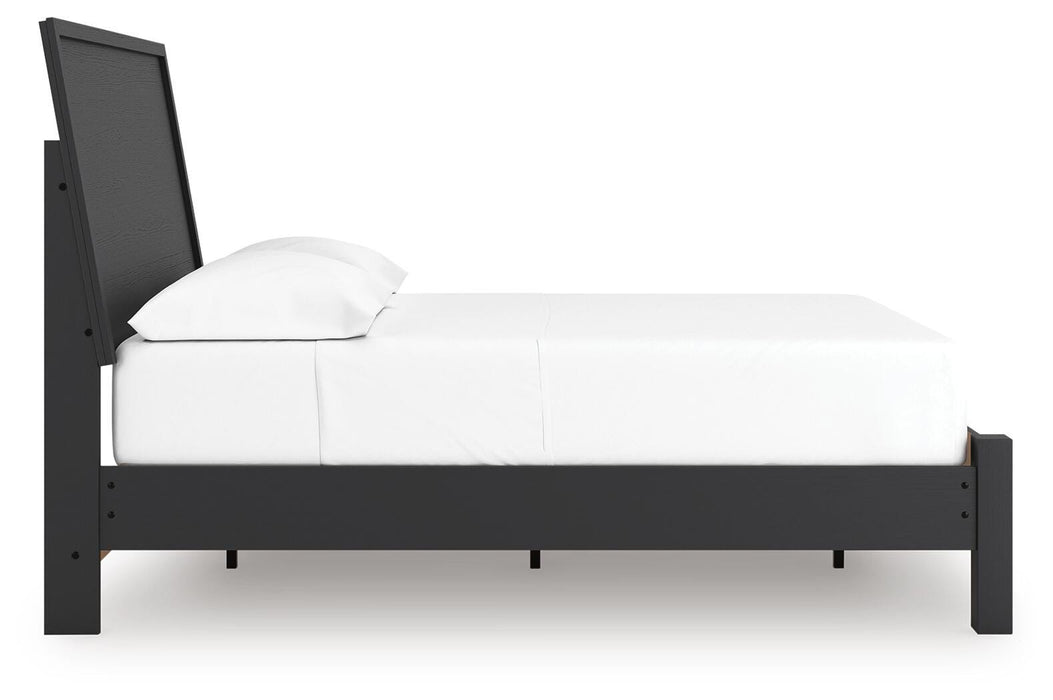 Ashley Furniture Danziar Bed with a sleek design and dark finish, shown from a side angle in a modern bedroom setting.