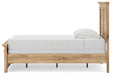 Ashley Furniture Makidern Bed with a modern design, showcasing a wooden frame and headboard in a bedroom setting.