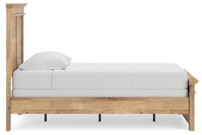Ashley Furniture Makidern bed with a side view showing the upholstered headboard and sleek wooden frame.