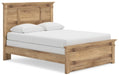 Ashley Furniture Makidern Bed with a sleek wooden frame and angled headboard, shown from a side angle in a modern bedroom setting.