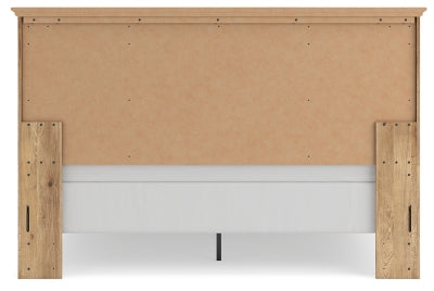 Ashley Furniture Makidern Bed with a wooden frame and headboard, shown from the back in a stylish bedroom setting.