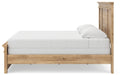 Ashley Furniture Makidern Bed showing a side view with a wooden frame and neutral upholstery, detailed headboard and footboard design.