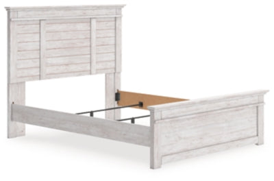 Ashley Furniture Makidern Bed with a sleek wooden frame and modern design, shown from an angled view.