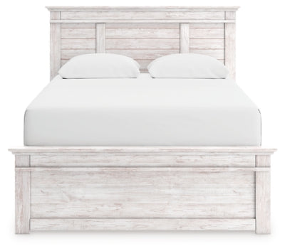 Ashley Furniture Makidern Bed with a sleek headboard and modern design, shown in a well-lit bedroom setting.