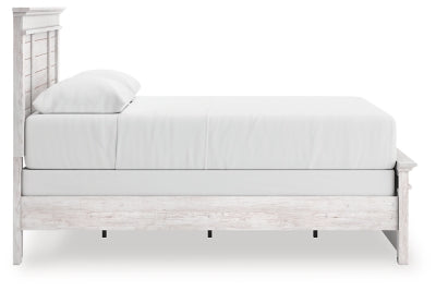 Ashley Furniture Makidern bed with a sleek wooden frame and side view showing the headboard and footboard design.