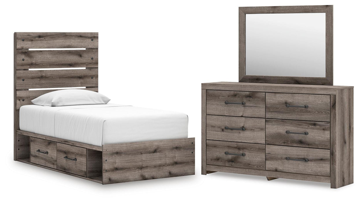 Gray Ashley Furniture bedroom set with a bed, nightstands, and dresser in a modern gray finish, displayed in a stylish bedroom.
