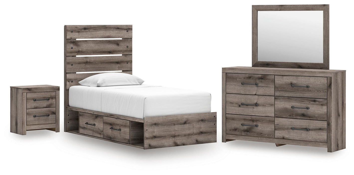 Gray Ashley Furniture bedroom set with a bed, nightstands, and dresser in a modern design, shown in a well-lit bedroom setting.
