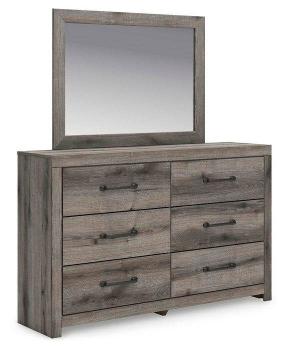 Ashley Furniture Graystorm bedroom set, featuring a gray upholstered bed frame and matching nightstands, in a modern bedroom setup.