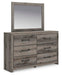 Graystorm bedroom set by Ashley Furniture, featuring a modern bed frame and matching nightstands, styled in a cozy bedroom scene.
