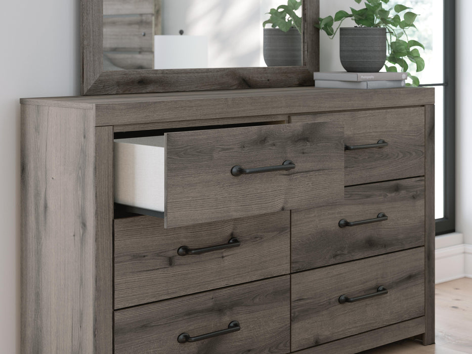 Graystorm bedroom set by Ashley Furniture featuring a modern gray bed frame and matching nightstands with sleek design details.