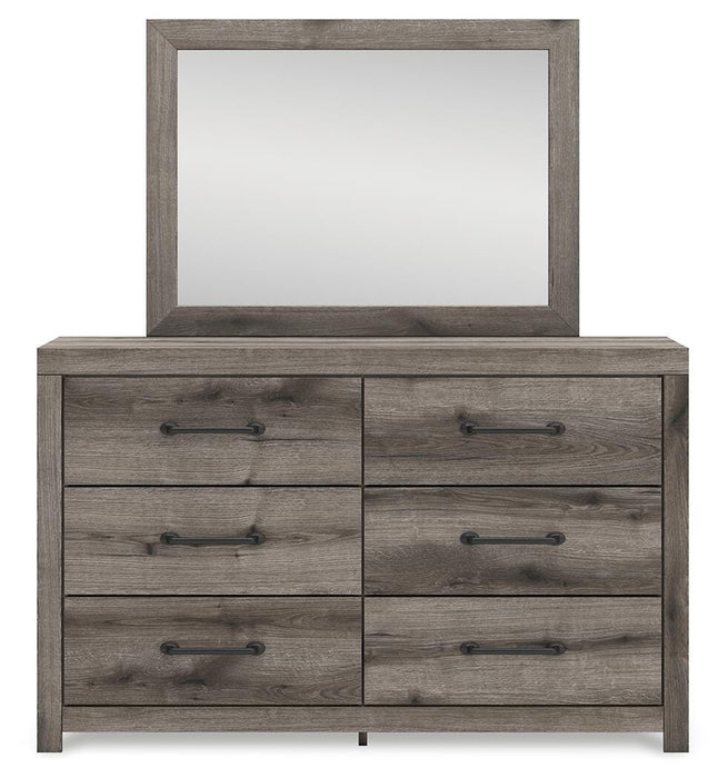 Graystorm bedroom set by Ashley Furniture featuring a bed with a gray upholstered headboard and matching nightstands.